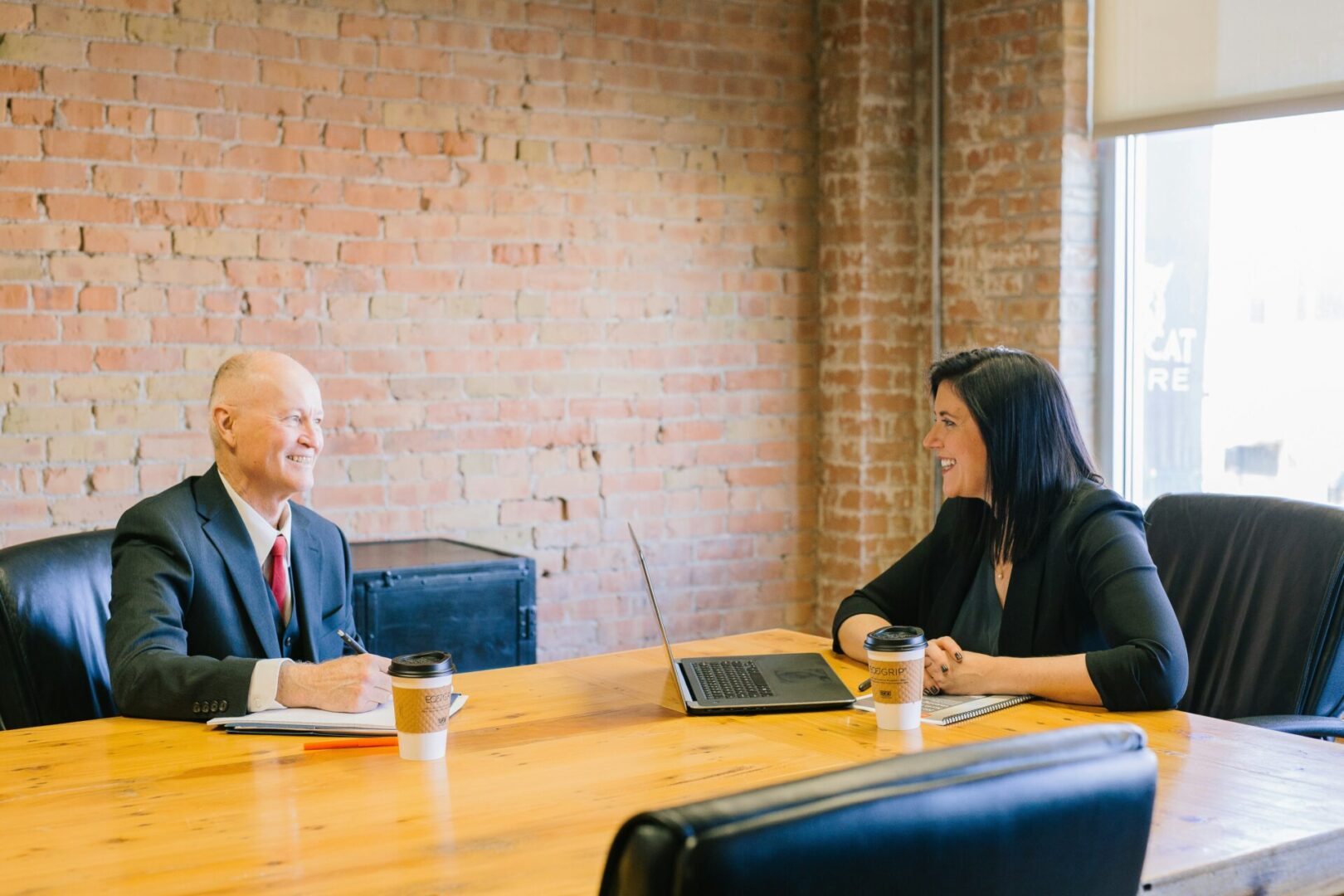 Two businesspeople meeting at a table.