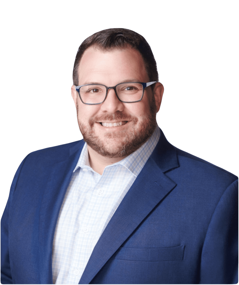 Smiling man in a blue suit and glasses.