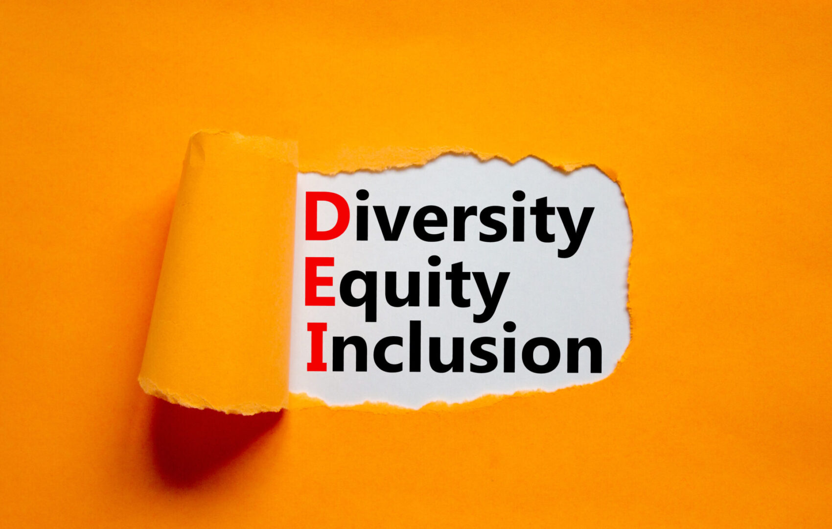 Diversity, equity, inclusion DEI symbol. Words DEI, diversity, equity, inclusion appearing behind torn orange paper. Orange background. Business, diversity, equity, inclusion concept, copy space.